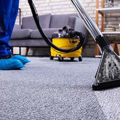 Stock image of a person cleaning carpet with tools