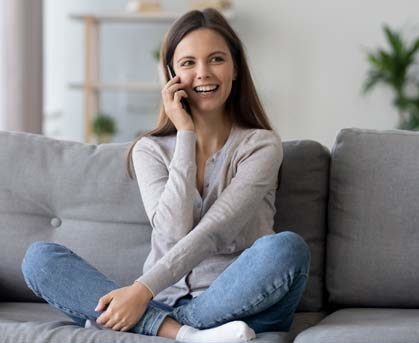 Stock image of a girl sitting and talking on phone