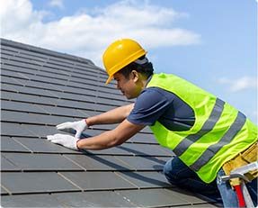 Stock image of a man working on roof