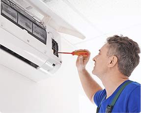 stock image of a man repairing Air conditioner