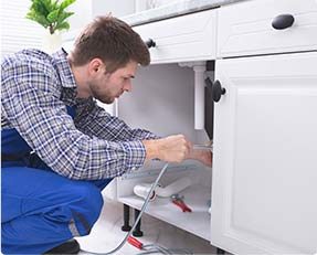 Stock image of a man doing plumbing work