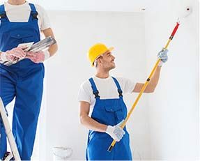 Stock image showing 2 persons painting a room