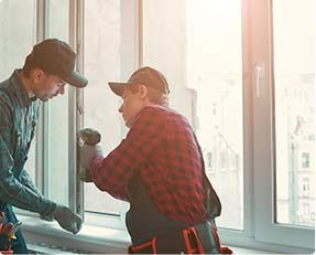 Stock image of 2 persons repairing windows